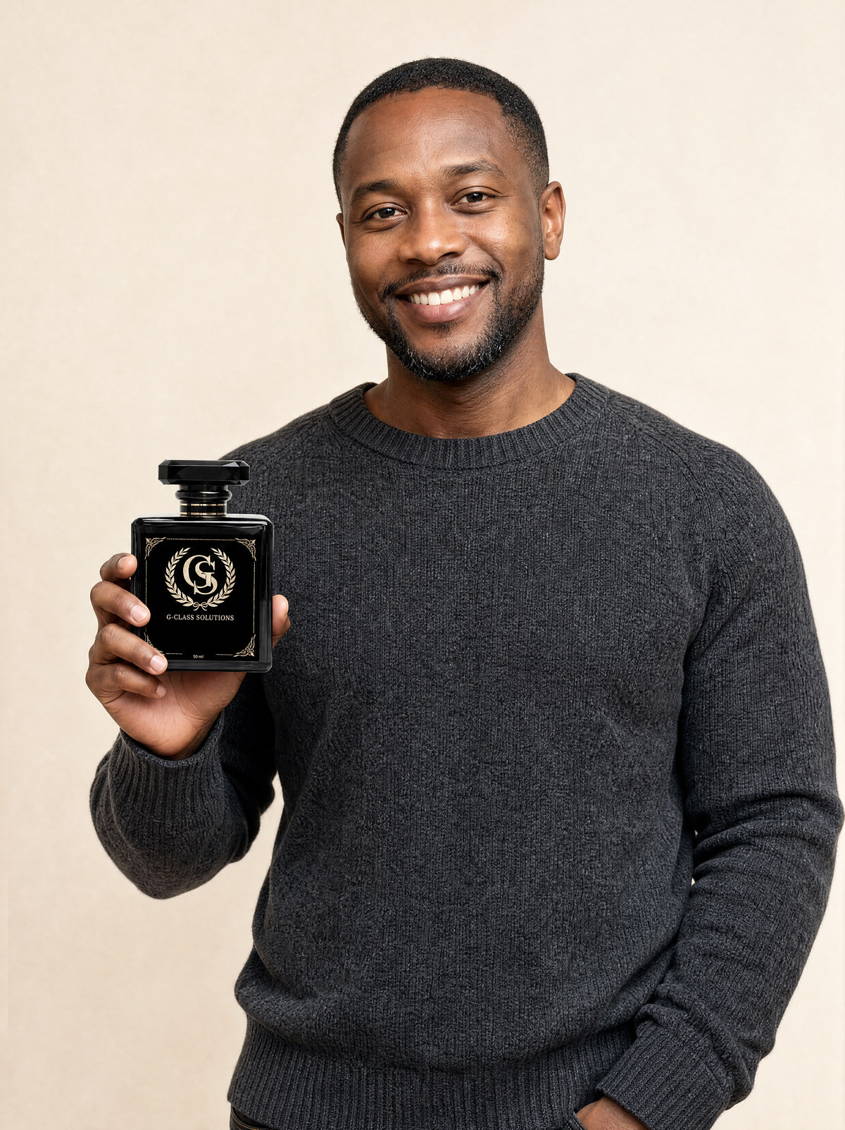 A man holding a G-Class Solutions perfume bottle