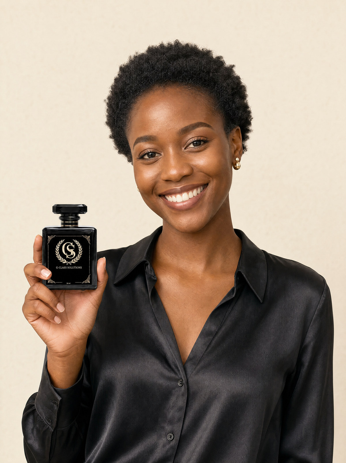 A woman holding a G-Class Solutions perfume bottle